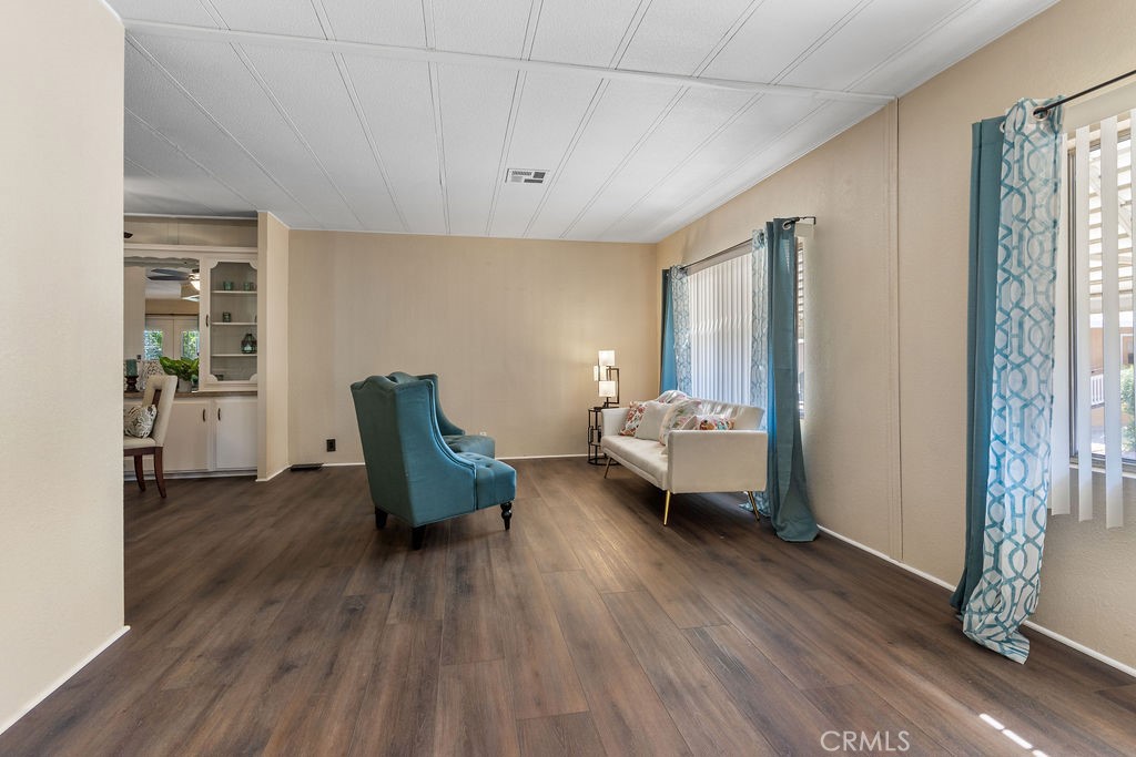 13393 Mariposa Road, Unit 99 Victorville, CA 92395 - Photo 8 of 50 a living room with furniture and a wooden floor
