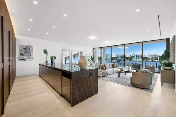 a living room with furniture dining table and a large window