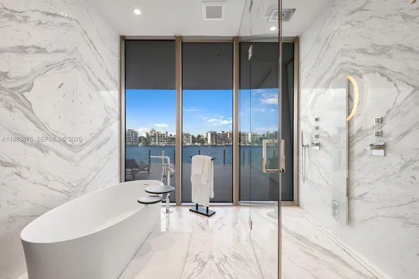 a bathroom with a double vanity sink a mirror and a bathtub