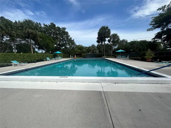 a view of a swimming pool and a yard