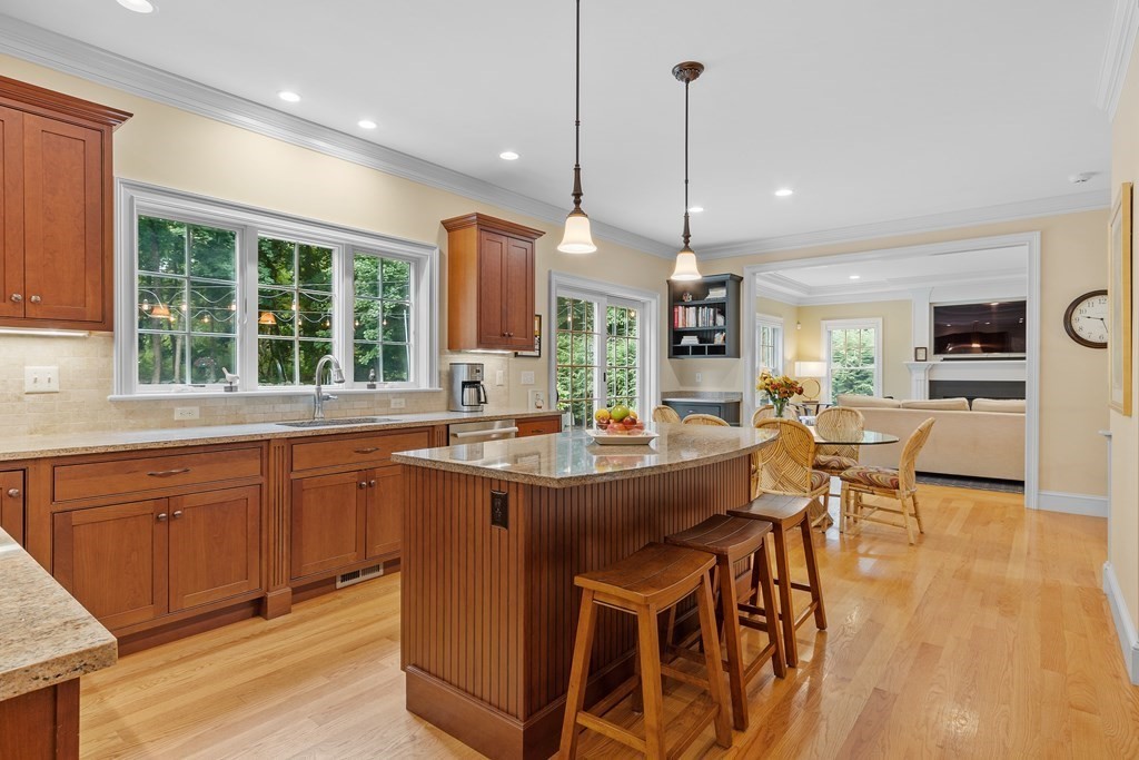 10 Parker Road Bedford, MA 01730 - Photo 14 of 38 a dining table with chairs and kitchen view