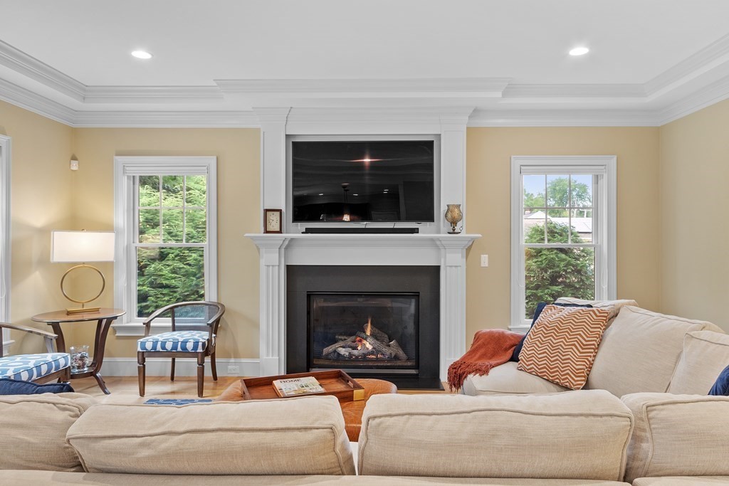 10 Parker Road Bedford, MA 01730 - Photo 20 of 38 a living room with furniture a flat screen tv and a fireplace