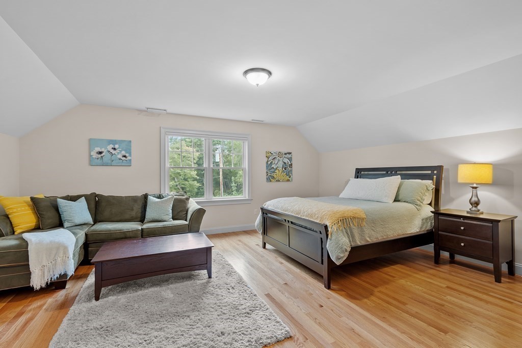 10 Parker Road Bedford, MA 01730 - Photo 29 of 38 a spacious bedroom with a bed a couch and window