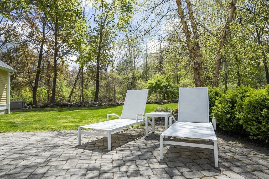 10 Parker Road Bedford, MA 01730 - Photo 33 of 38 a view of a chairs and table in backyard of the house