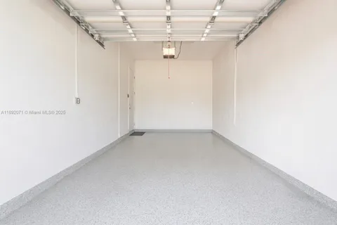 a view of a lake with a table chairs and potted plants