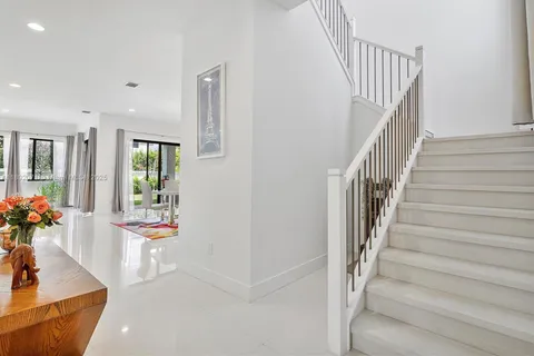 a living room with furniture and a baby crib
