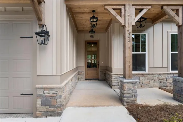 a bathroom with a granite countertop tub sink and mirror