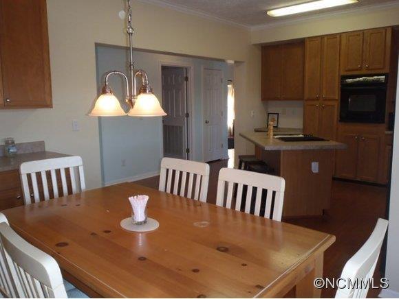 1585 Gilmer Edwards Road Rutherfordton, NC 28139 - Photo 13 of 23 a kitchen with a table chairs and a chandelier