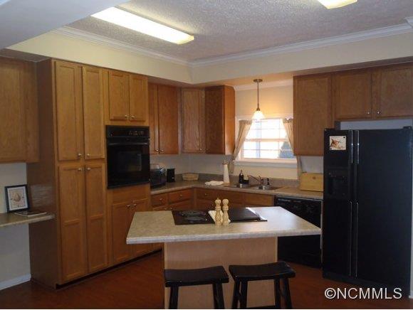 1585 Gilmer Edwards Road Rutherfordton, NC 28139 - Photo 3 of 23 a kitchen with a sink a refrigerator and cabinets