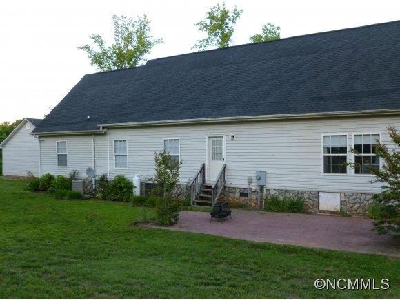 1585 Gilmer Edwards Road Rutherfordton, NC 28139 - Photo 6 of 23 a backyard of a house with plants and barbeque oven