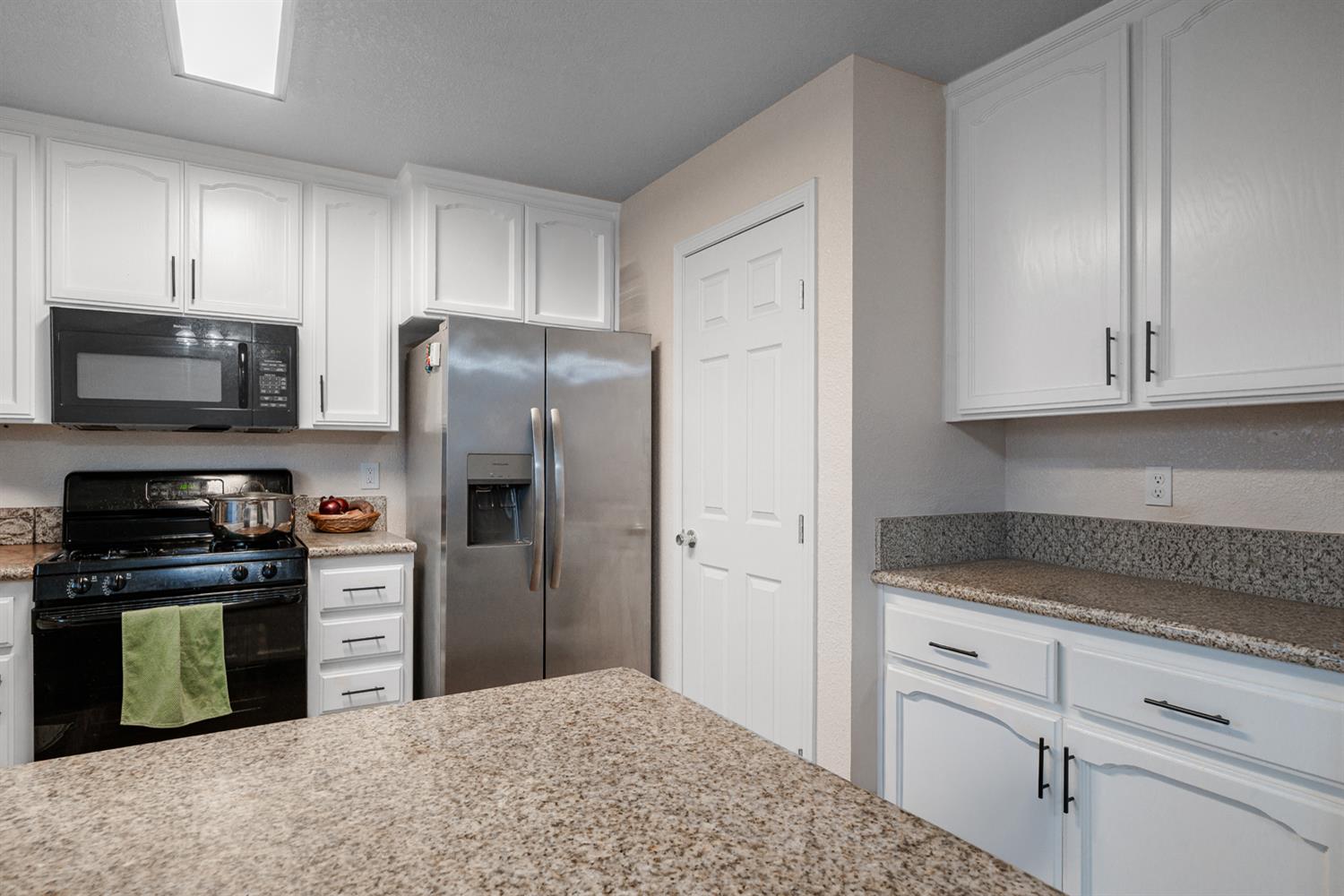1935 Madison Drive Madera, CA 93638 - Photo 11 of 22 a kitchen with a refrigerator stove and microwave