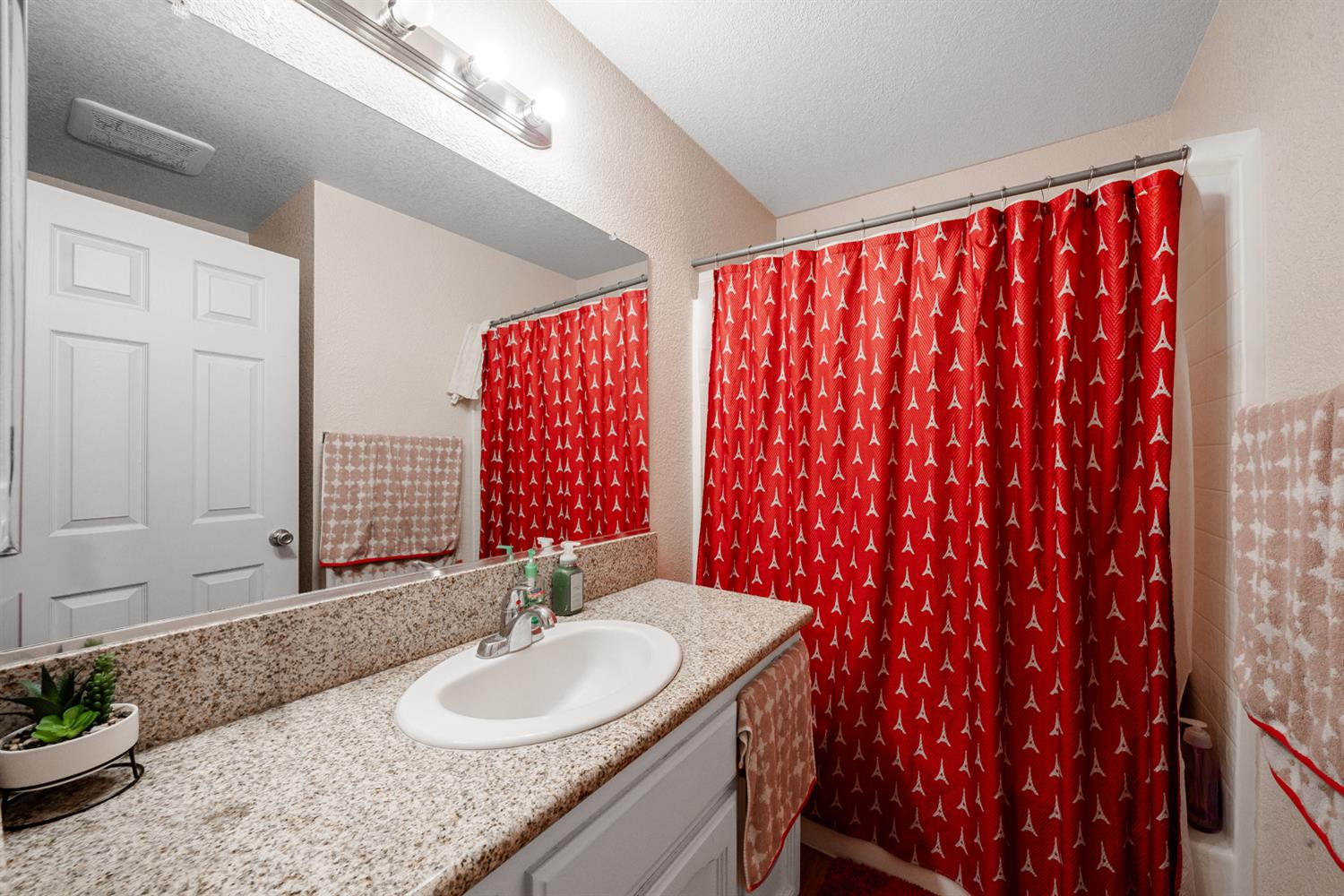 1935 Madison Drive Madera, CA 93638 - Photo 12 of 22 a bathroom with a granite countertop sink and a mirror
