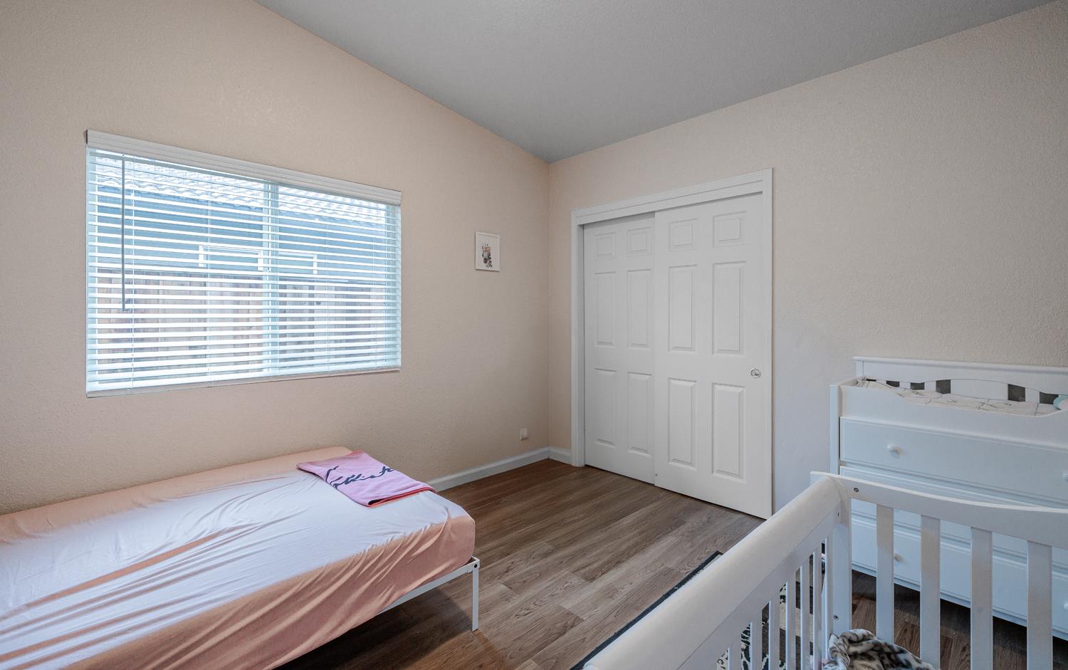 1935 Madison Drive Madera, CA 93638 - Photo 15 of 22 a bedroom with a bed and a window