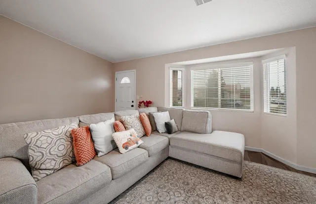 a living room with furniture and a large window