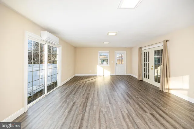 a bathroom with a granite countertop toilet sink and mirror