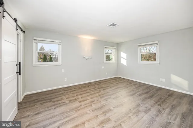 a bathroom with a granite countertop sink toilet a mirror and shower