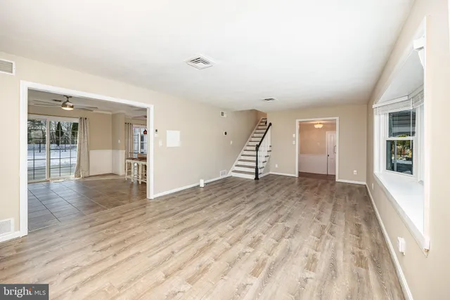 a large white kitchen with a large window