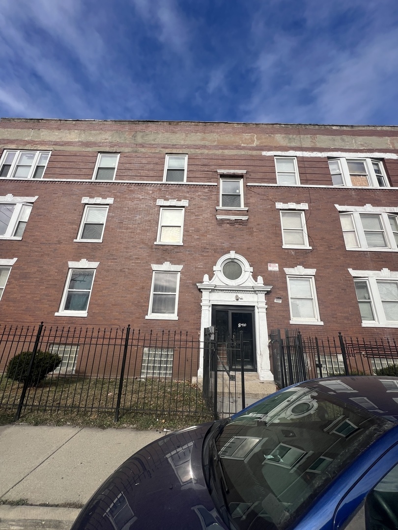 840 West 66th Street, Unit 2 Chicago, IL 60621 - Photo 1 of 7 a front view of a house with a yard