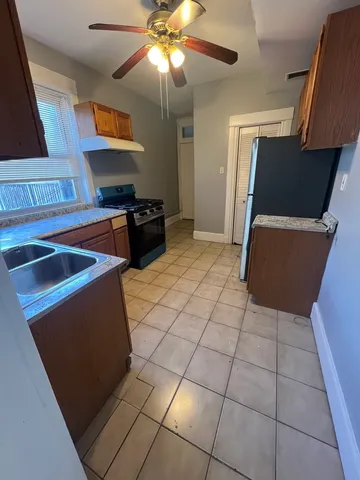 a kitchen with stainless steel appliances a stove a microwave and a refrigerator