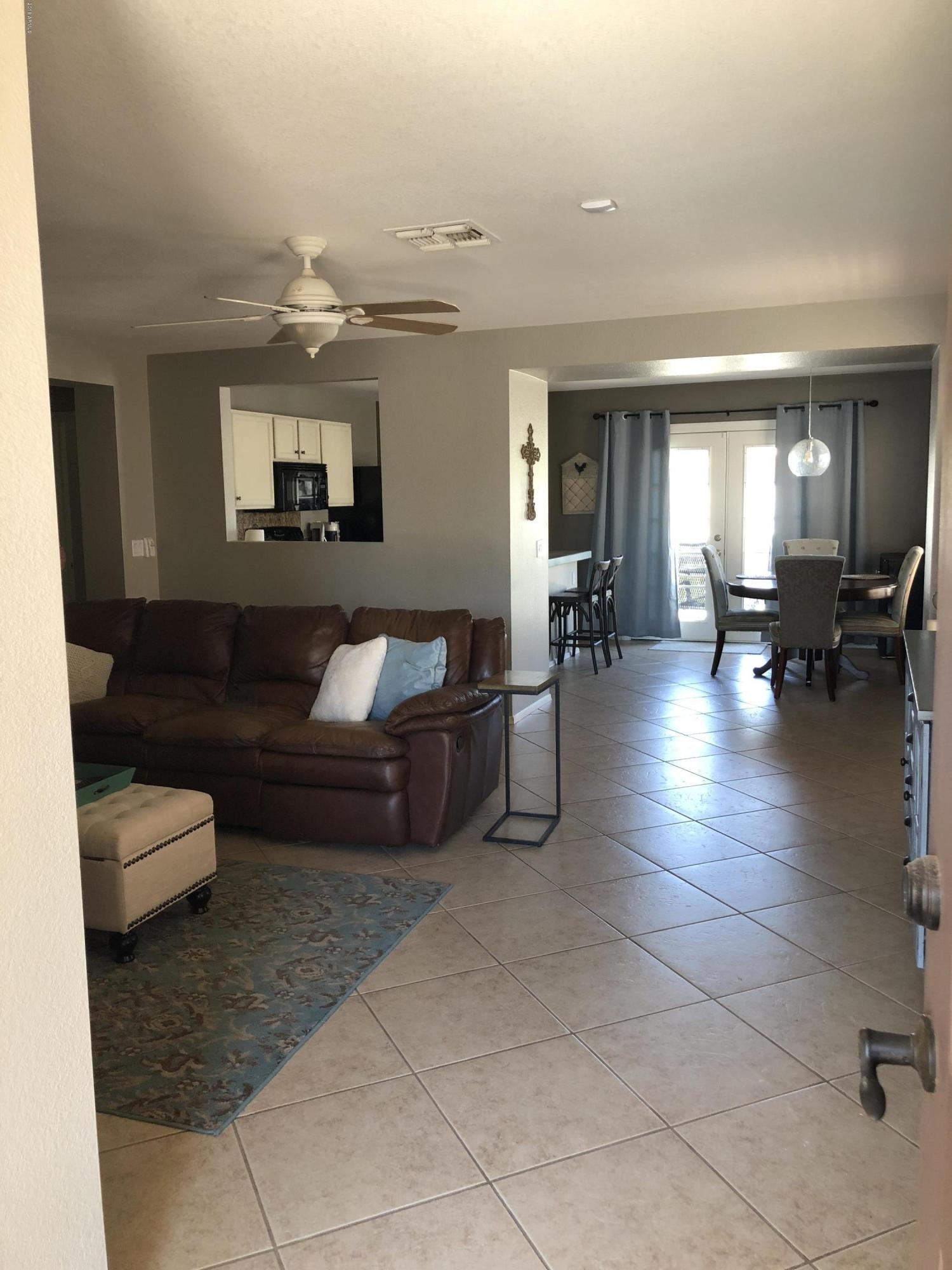 5112 East Peak View Road Cave Creek, AZ 85331 - Photo 11 of 18 a living room with furniture and a lamp