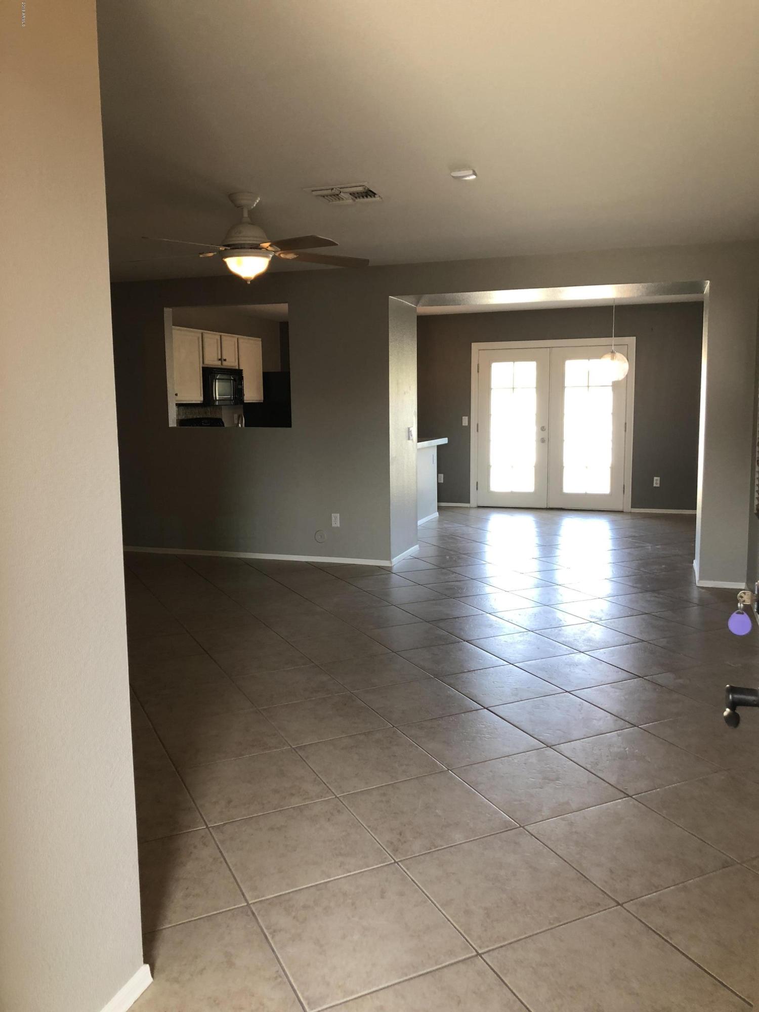 5112 East Peak View Road Cave Creek, AZ 85331 - Photo 12 of 18 a view of a hallway with wooden floor and a living room