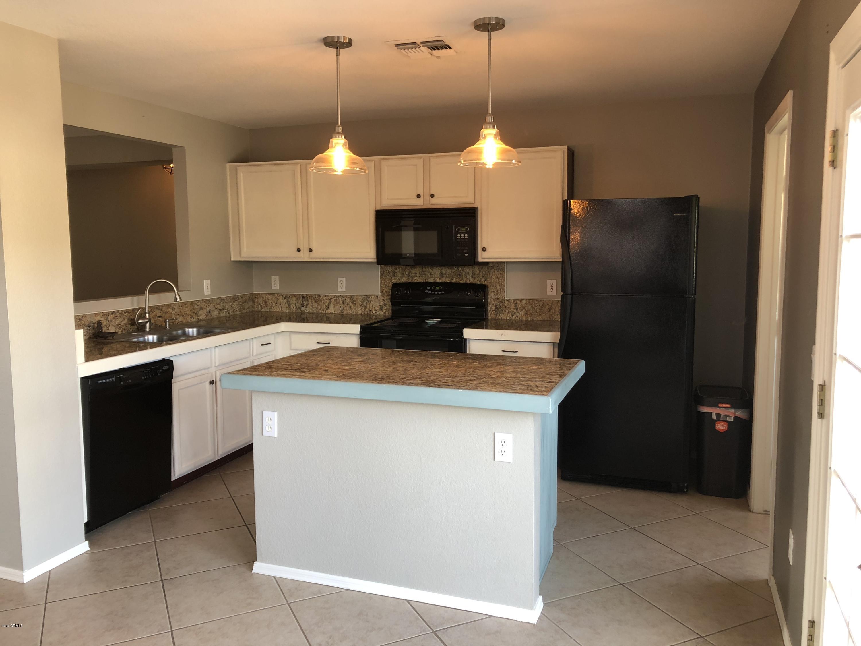 5112 East Peak View Road Cave Creek, AZ 85331 - Photo 13 of 18 a kitchen with a sink a counter top space a refrigerator and cabinets
