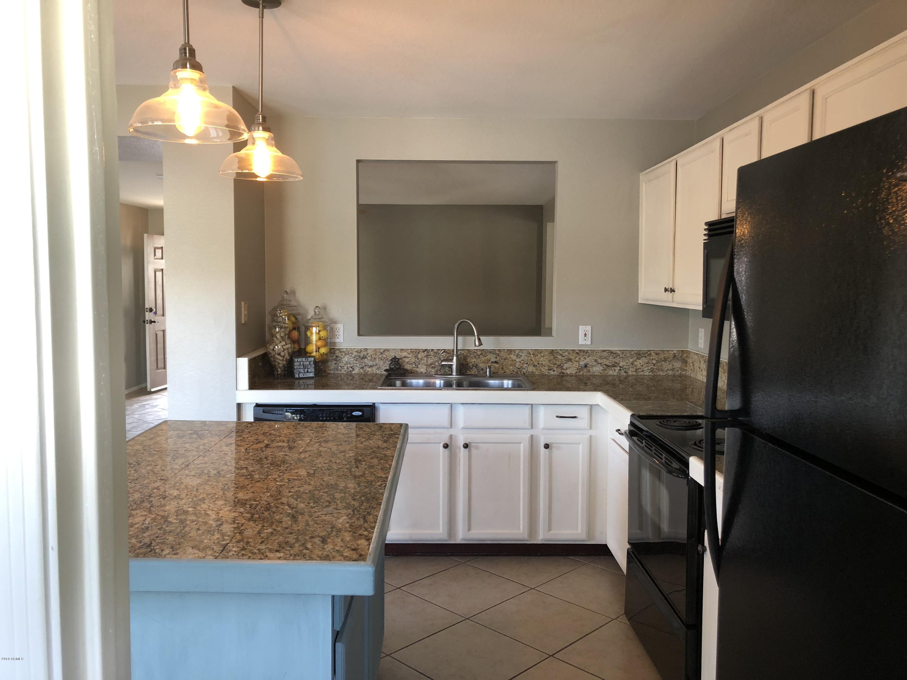 5112 East Peak View Road Cave Creek, AZ 85331 - Photo 14 of 18 a kitchen with stainless steel appliances granite countertop a refrigerator and a sink