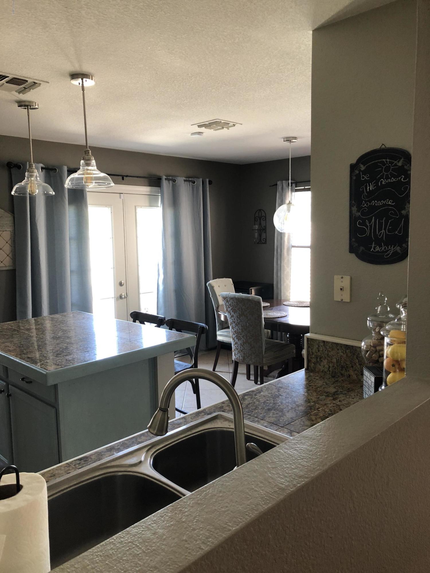 5112 East Peak View Road Cave Creek, AZ 85331 - Photo 6 of 18 a kitchen with kitchen island a stove and a sink