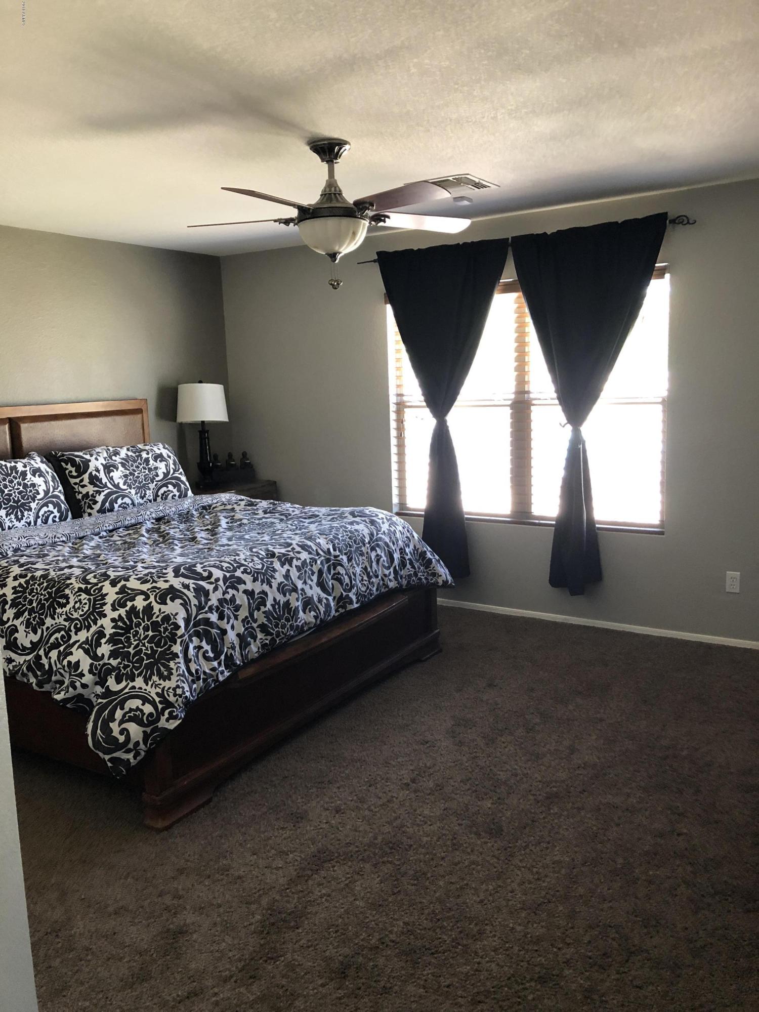 5112 East Peak View Road Cave Creek, AZ 85331 - Photo 7 of 18 a bedroom with a bed and window