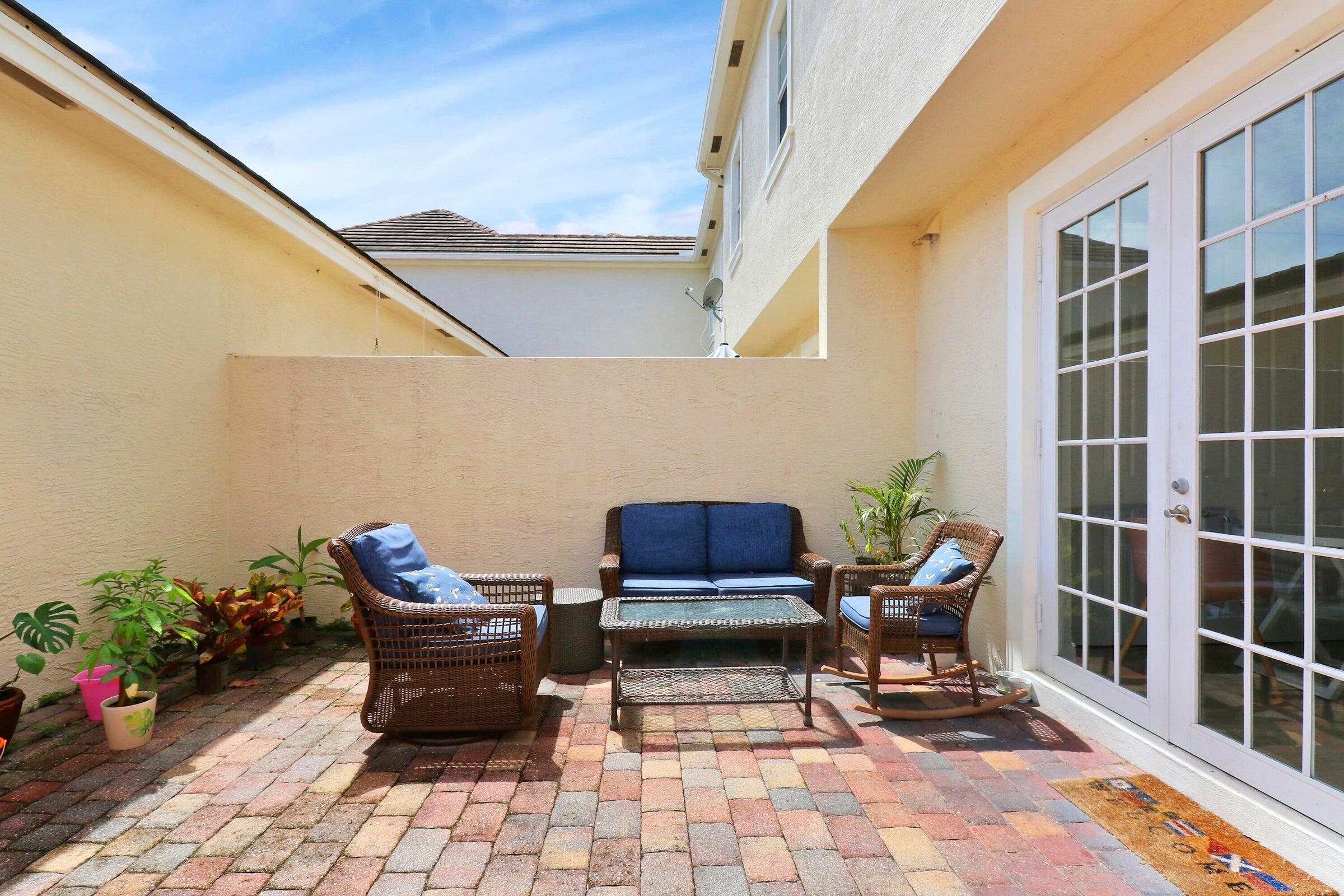 151 Mulligan Place Jupiter, FL 33458 - Photo 14 of 23 a building outdoor space with patio furniture and potted plants