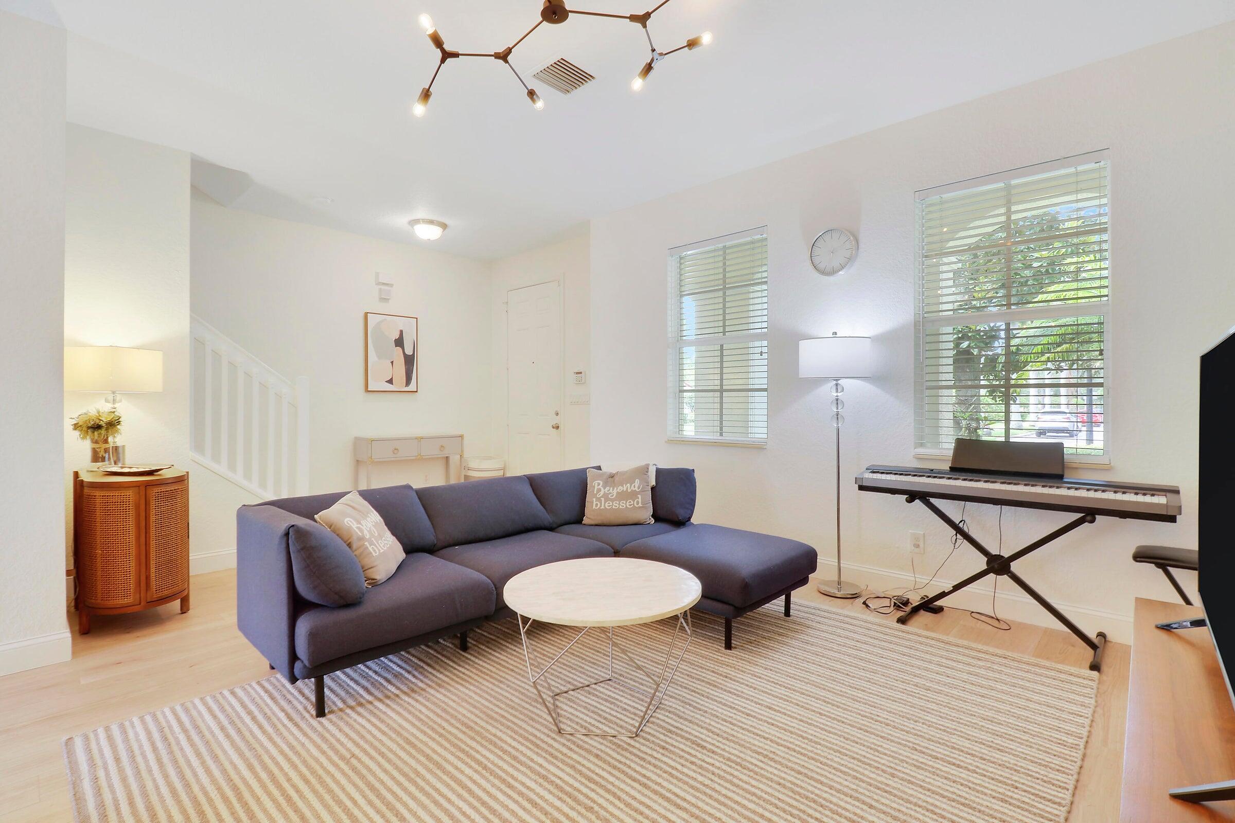 151 Mulligan Place Jupiter, FL 33458 - Photo 7 of 23 a living room with furniture and a wooden floor