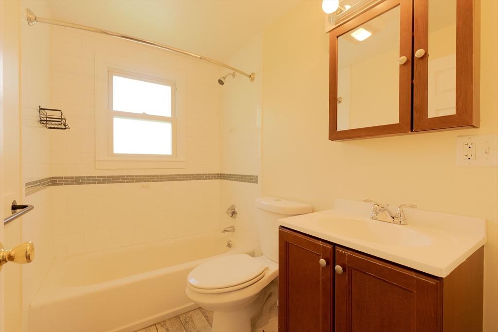 89 Brayton Road, Unit 2 Boston, MA 02135 - Photo 4 of 29 a bathroom with a sink a toilet and shower