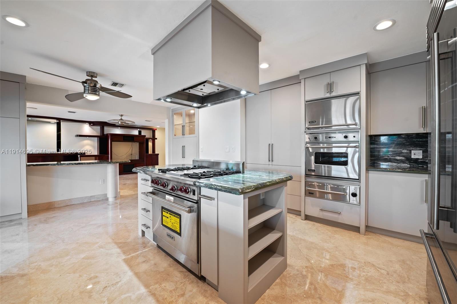 2015 Northeast 120th Road North Miami, FL 33181 - Photo 16 of 67 a kitchen with stainless steel appliances granite countertop a stove and a refrigerator