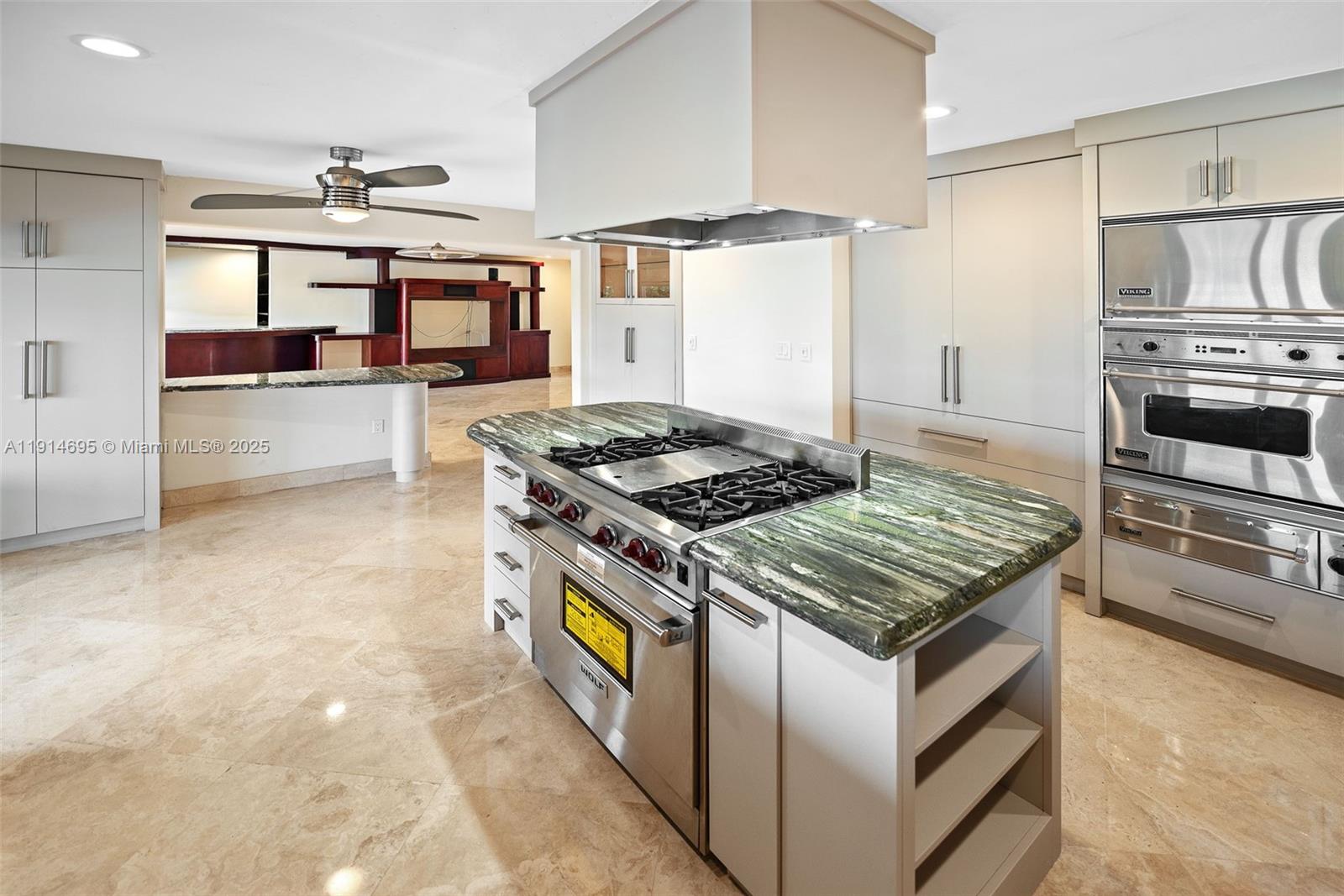 2015 Northeast 120th Road North Miami, FL 33181 - Photo 17 of 67 a kitchen with stainless steel appliances granite countertop a stove and a refrigerator