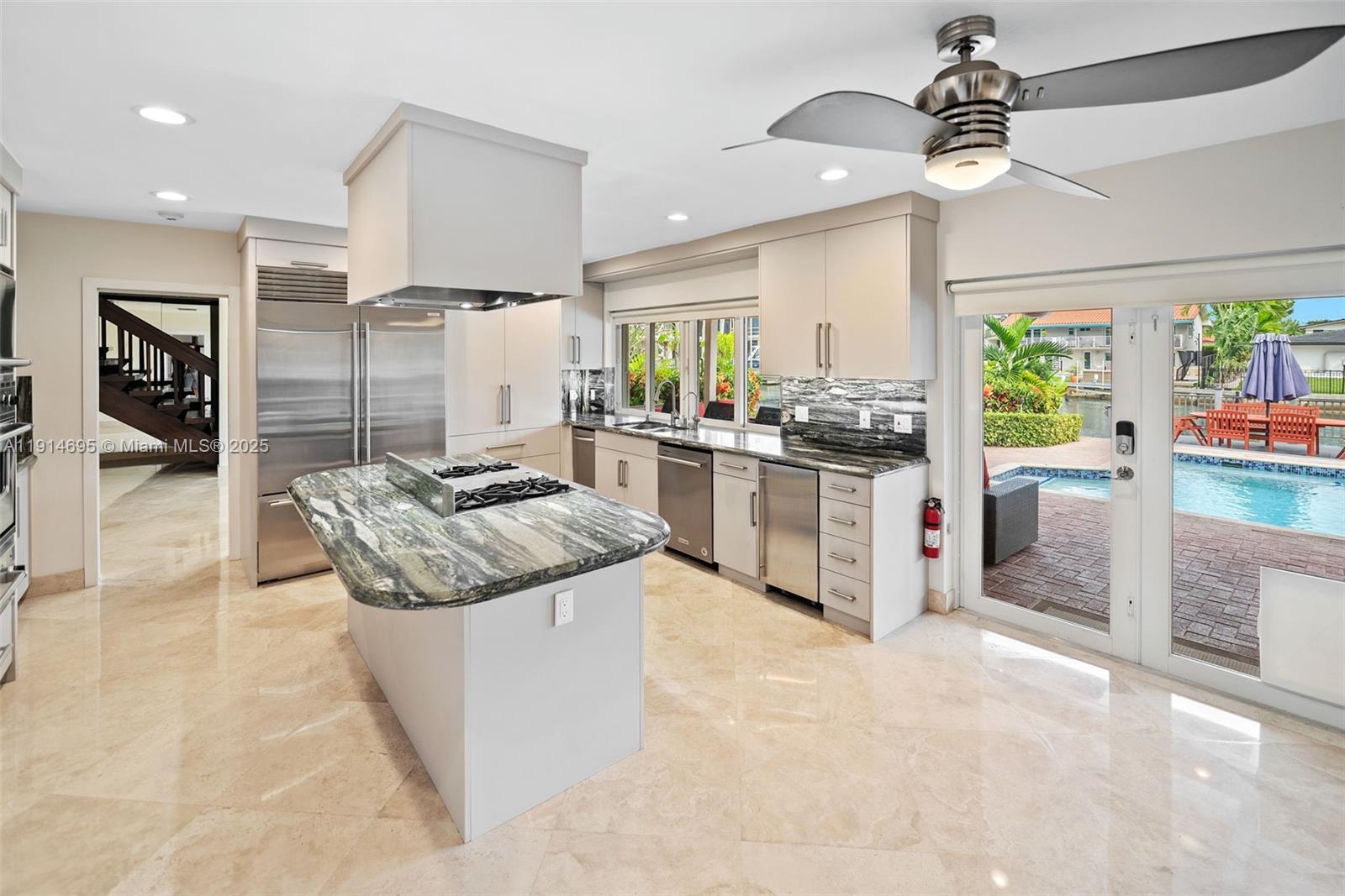 2015 Northeast 120th Road North Miami, FL 33181 - Photo 19 of 67 a kitchen with stainless steel appliances granite countertop a stove oven and a refrigerator with the cabinets