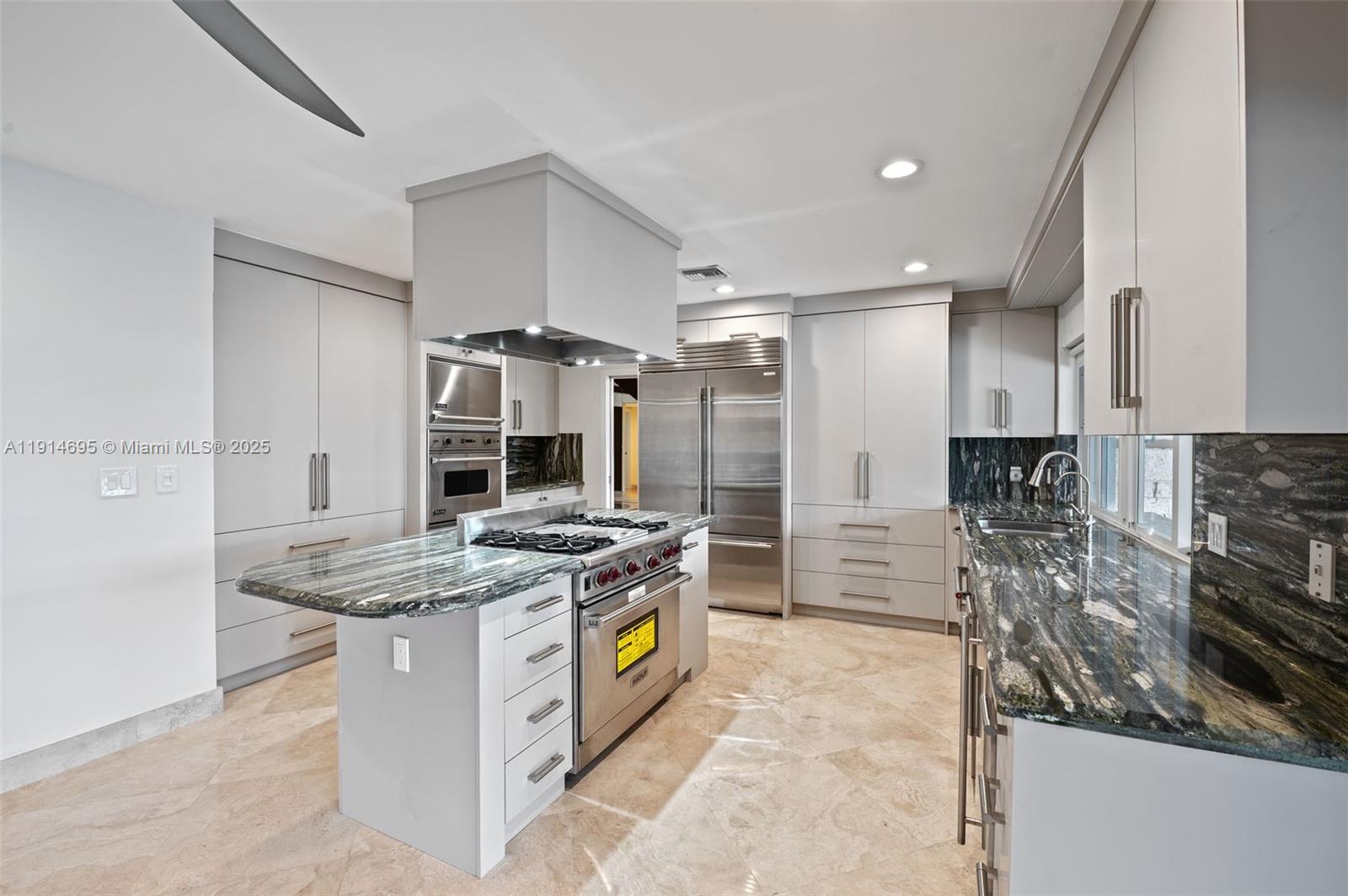 2015 Northeast 120th Road North Miami, FL 33181 - Photo 21 of 67 a kitchen with stainless steel appliances granite countertop a stove and a sink