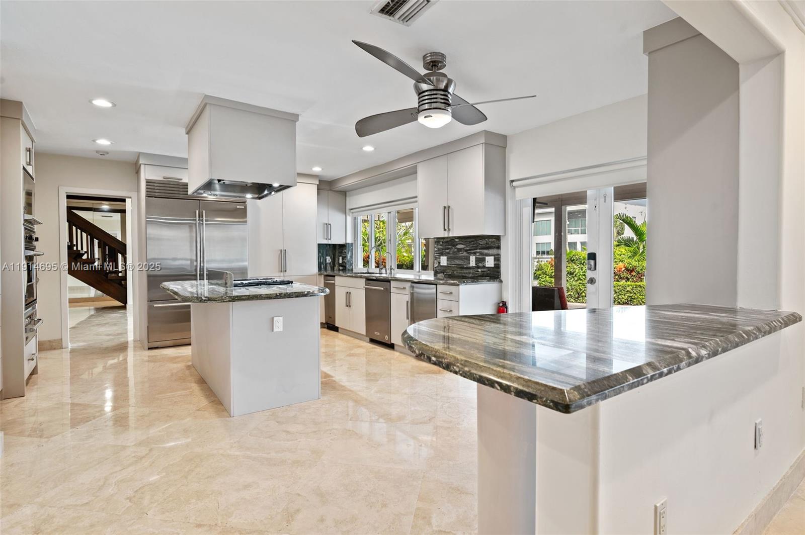2015 Northeast 120th Road North Miami, FL 33181 - Photo 22 of 67 a kitchen with kitchen island a counter top space appliances and a center island
