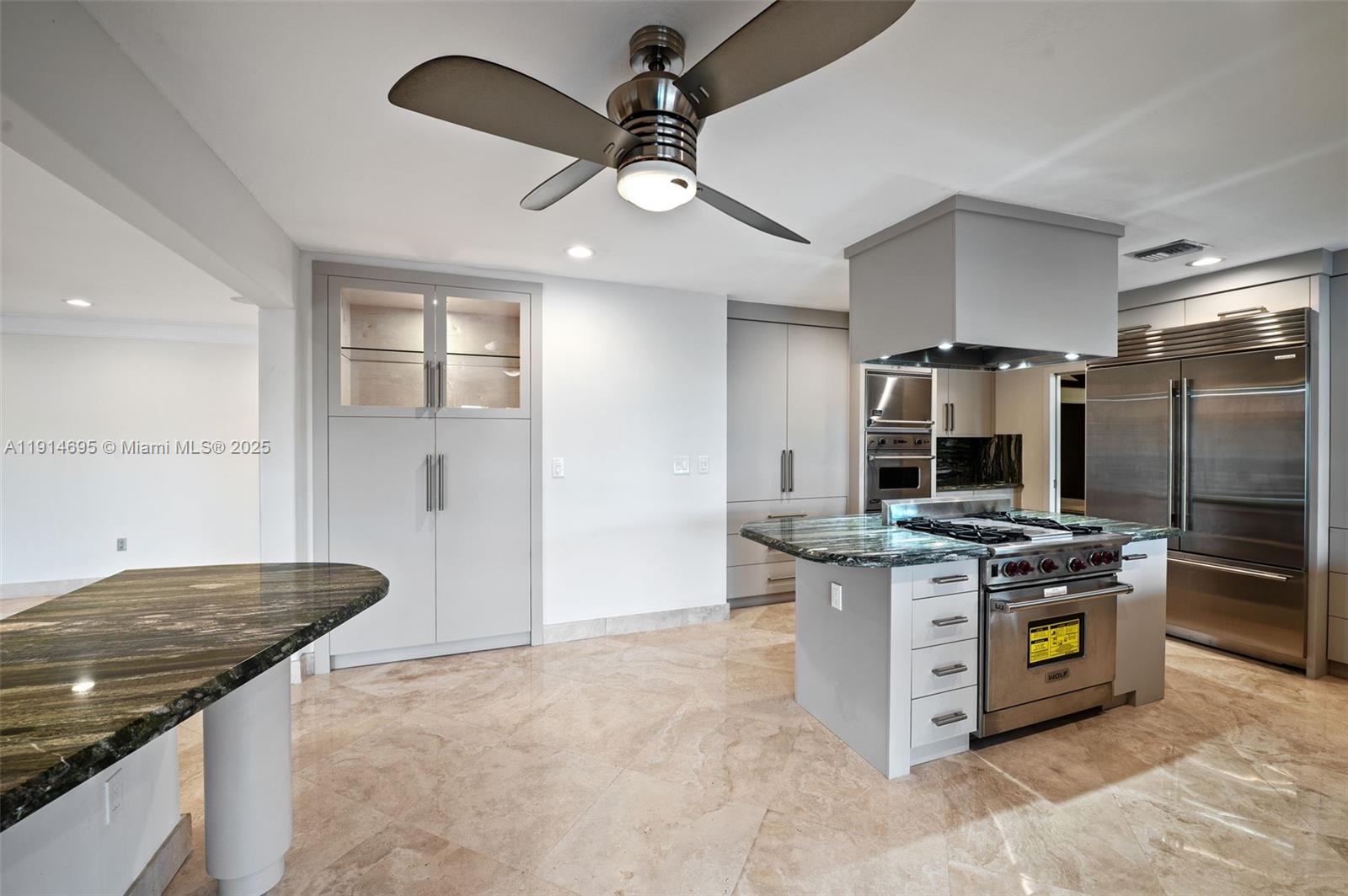 2015 Northeast 120th Road North Miami, FL 33181 - Photo 23 of 67 a kitchen with stainless steel appliances granite countertop a stove and a refrigerator