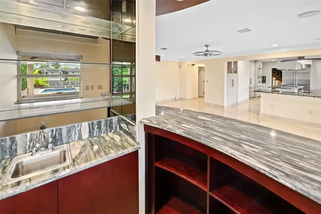 a bathroom with a granite countertop sink a toilet and shower