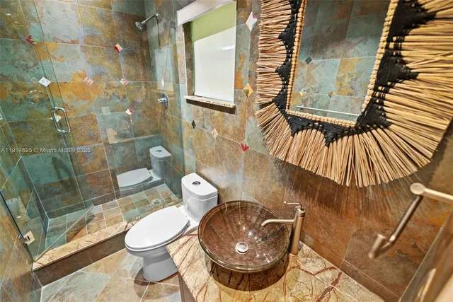 a bathroom with a granite countertop tub sink and mirror