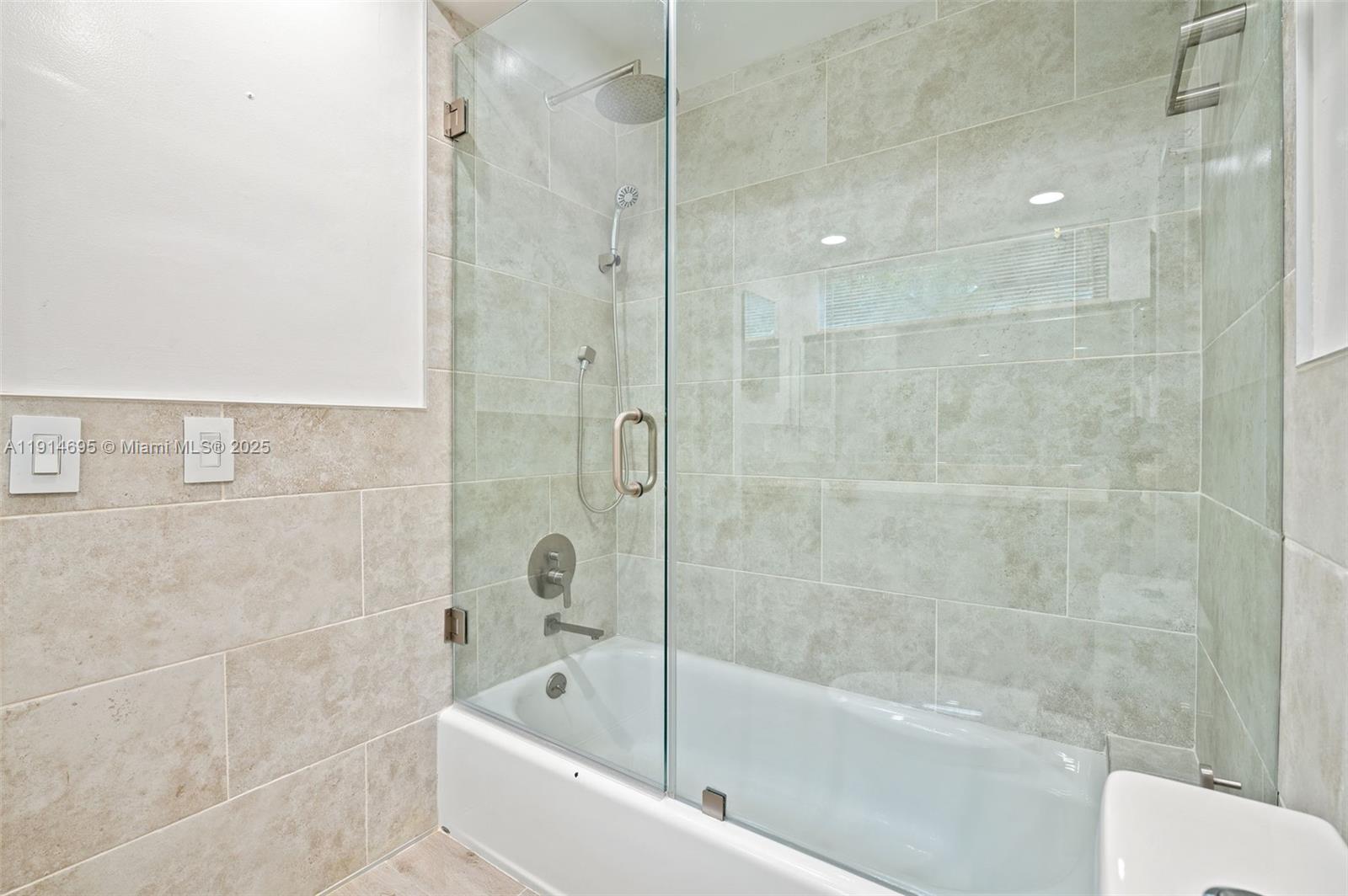 2015 Northeast 120th Road North Miami, FL 33181 - Photo 35 of 67 a bathroom with a bathtub and shower