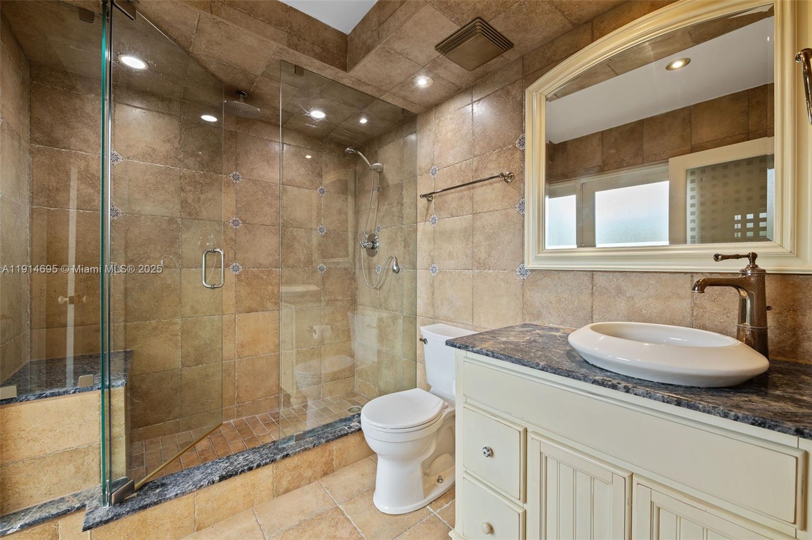 2015 Northeast 120th Road North Miami, FL 33181 - Photo 39 of 67 a bathroom with a granite countertop sink a toilet and shower