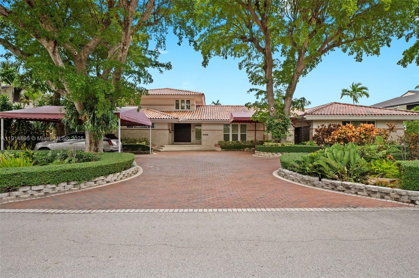 2015 Northeast 120th Road North Miami, FL 33181 - Photo 4 of 67 a front view of a house with a yard and green space