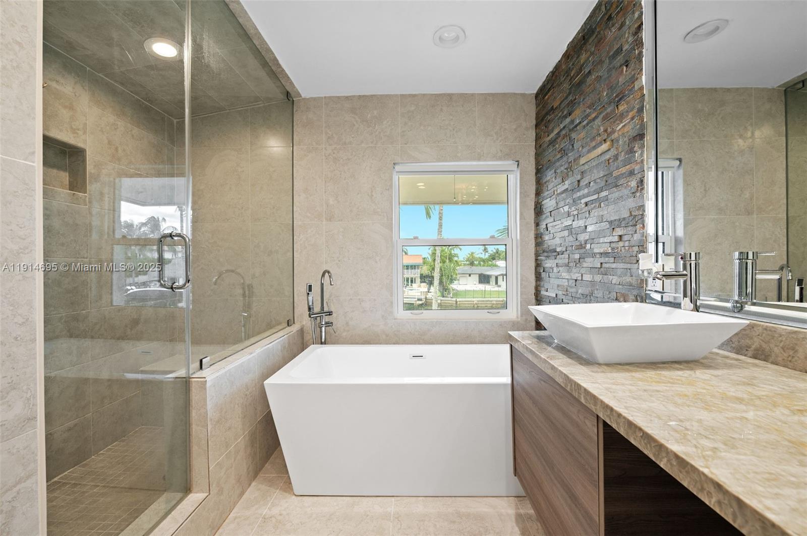 2015 Northeast 120th Road North Miami, FL 33181 - Photo 44 of 67 a bathroom with a granite countertop tub sink and mirror