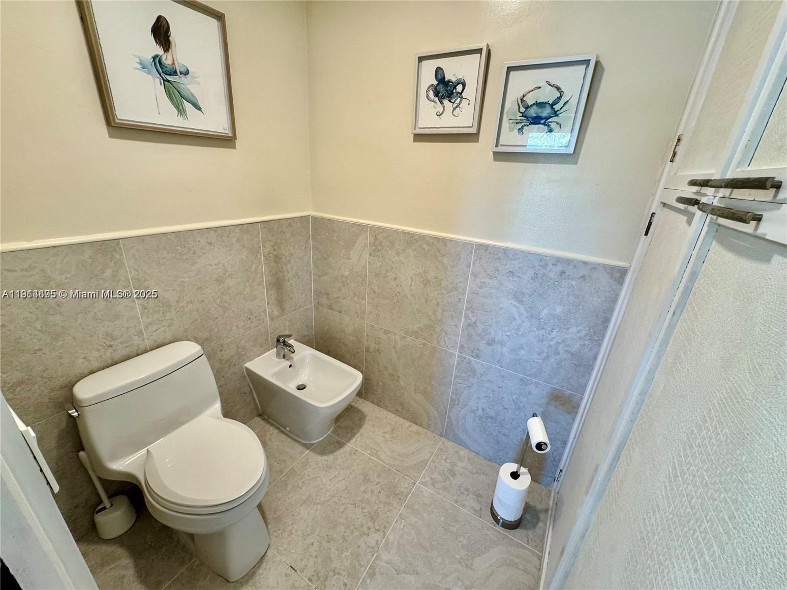 2015 Northeast 120th Road North Miami, FL 33181 - Photo 46 of 67 a white toilet sitting next to a bathroom sink