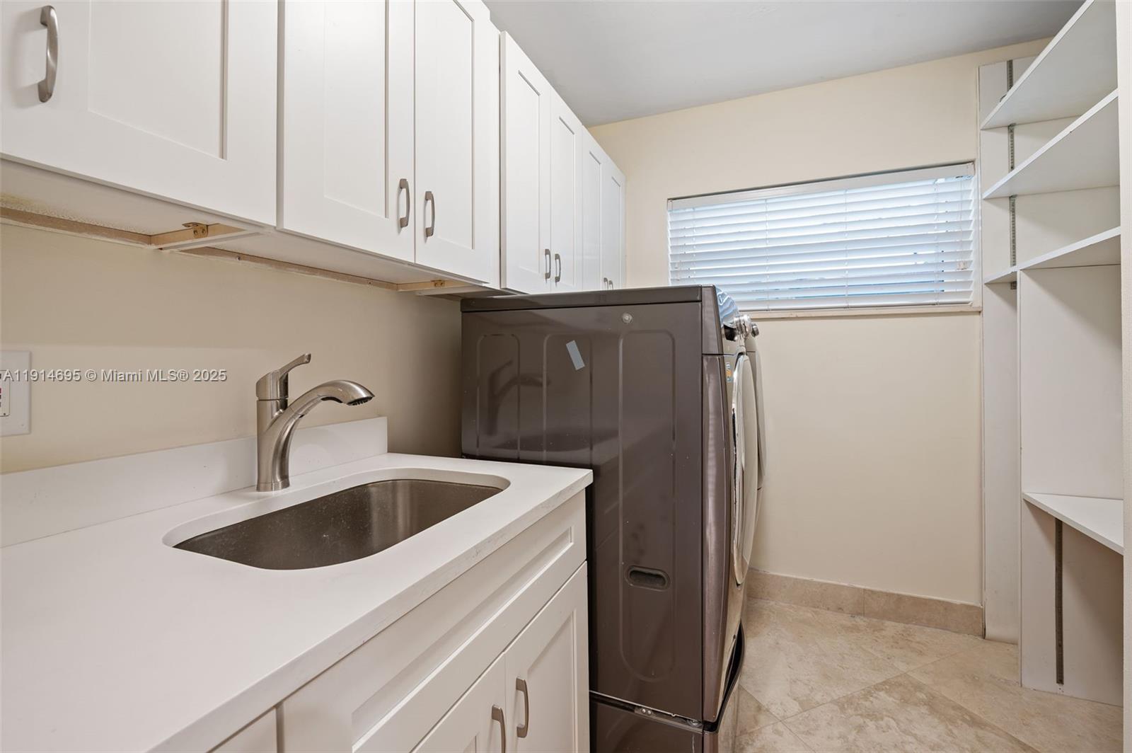 2015 Northeast 120th Road North Miami, FL 33181 - Photo 58 of 67 a kitchen with stainless steel appliances granite countertop a sink and a refrigerator