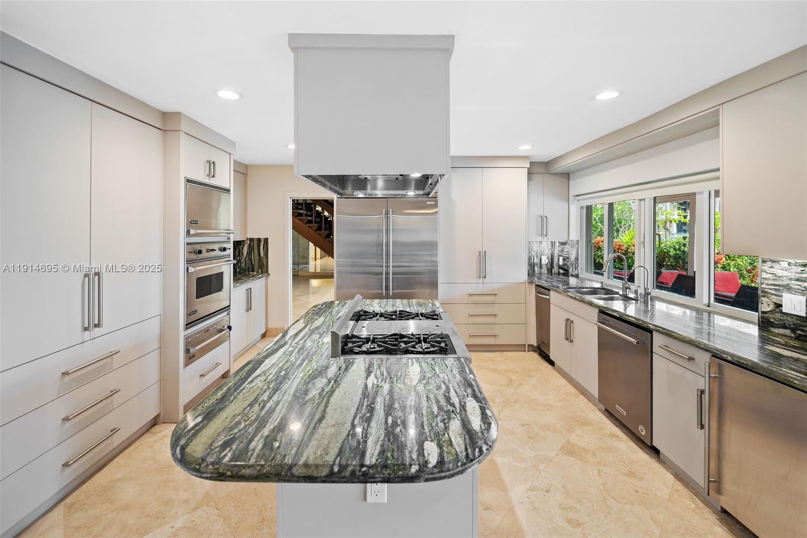 2015 Northeast 120th Road North Miami, FL 33181 - Photo 7 of 67 a kitchen with granite countertop a stove and cabinets