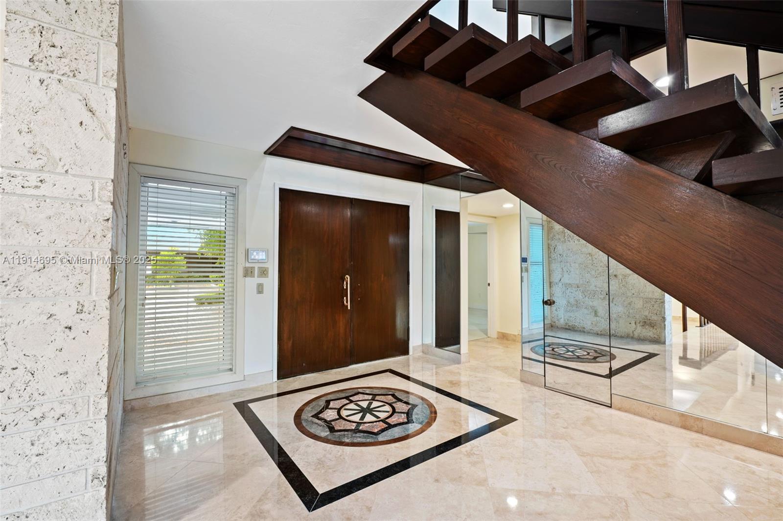 2015 Northeast 120th Road North Miami, FL 33181 - Photo 9 of 67 a view of a hallway with wooden floor and staircase