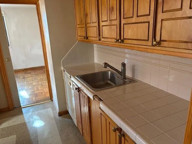 a kitchen with a sink and large window