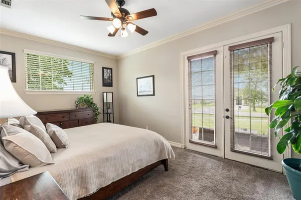 a bedroom with a bed and glass window